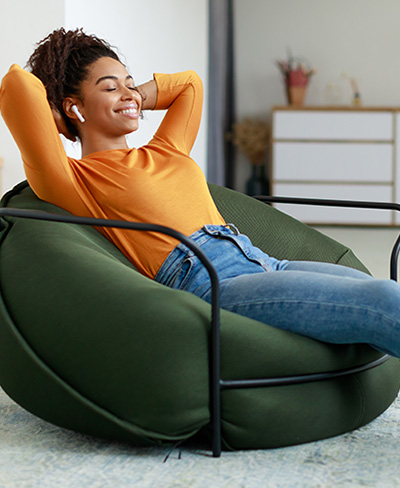 calm woman sitting in beanbag chair calm woman sitting in beanbag chair