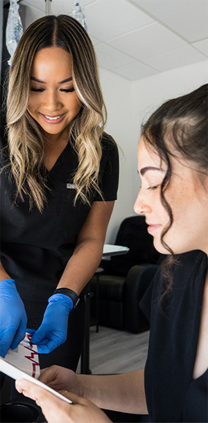 a 10X Health team member reviews a pamphlet with a visitor