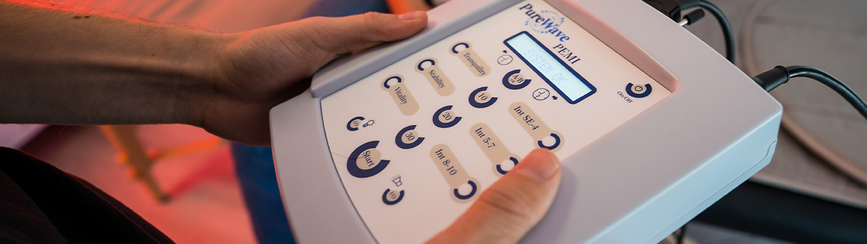 person holding the Superhuman Protocol PEMF device