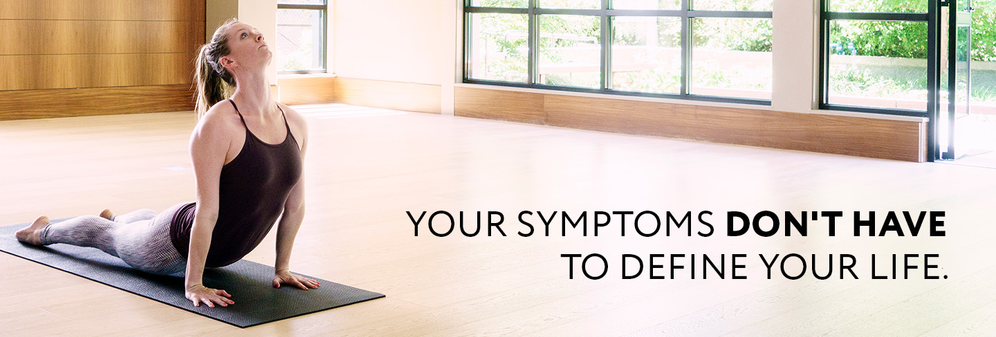 photo of a woman doing yoga with the text "your symptoms don't have to define your life." laid over it photo of a woman doing yoga with the text "your symptoms don't have to define your life." laid over it