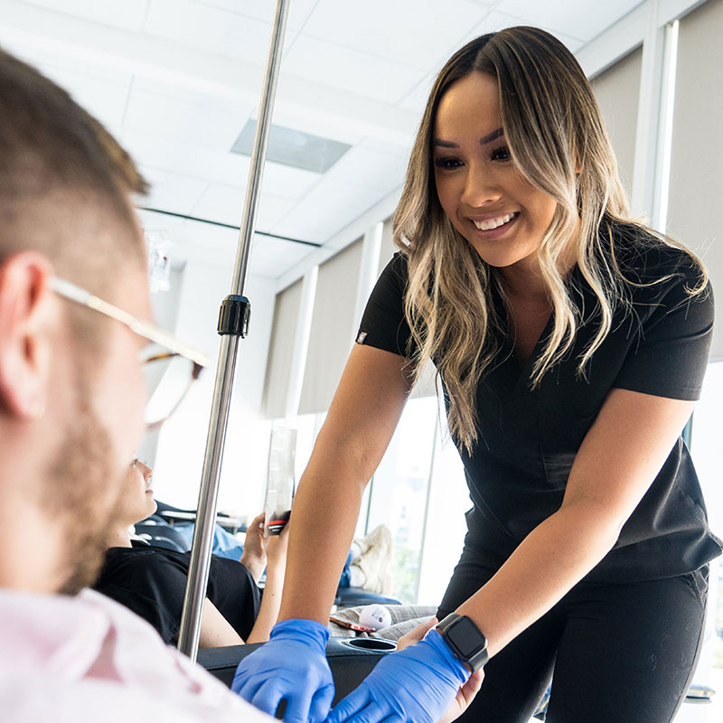 a 10X Health team member prepping a visitor for a blood test